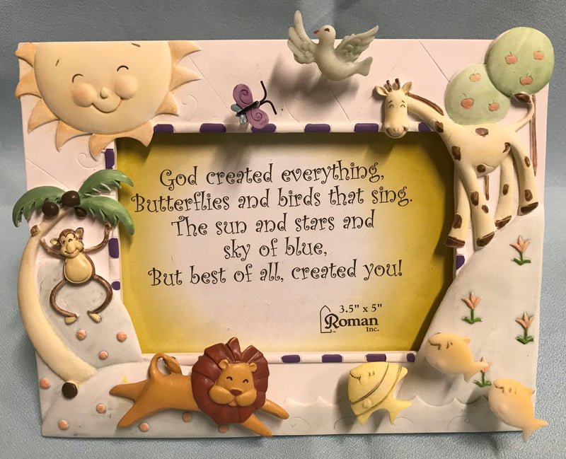Picture frame with sun and animals.