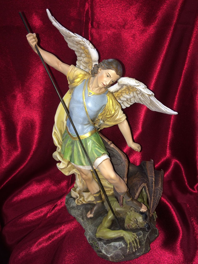 Front view of St. Michael statue. He is stepping on the devil. 